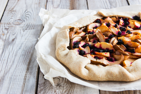 Rustic apple and black currant pie galette with a buttery crust.の写真素材