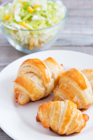Cheese croissant and vegetarian salad.の写真素材
