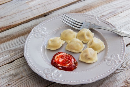 Russian meat dumplings pelmeni wooden background.の写真素材