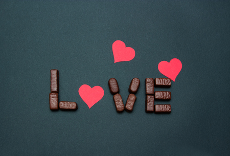 Valentines background with chocolate letters and cardboard hearts.の写真素材