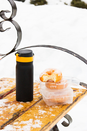 Donuts thermos bench park outdoors winter coldの写真素材
