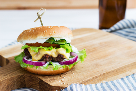 Tasty beef burgers wooden cutting board cotton napkin.の写真素材