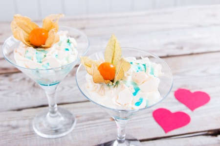 Two desserts pav meringue with cardboard hearts.の写真素材