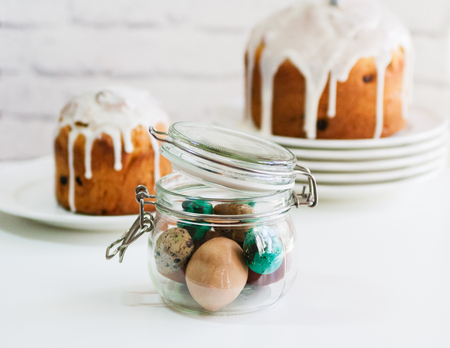 Easter cake and painted eggs in jar.