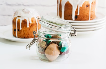 Easter cake and painted eggs in jar.の写真素材