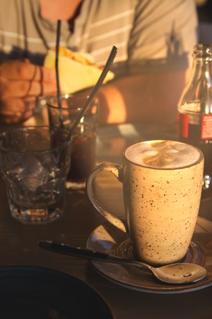 Latte cup caucasian white man hands sparkling water.の写真素材