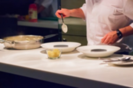 Defocused blur Restaurant kitchen cooking chef dish white tableの写真素材