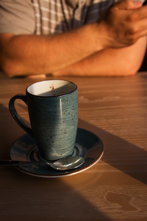 Evening latte cafe two mugs wooden table.の写真素材
