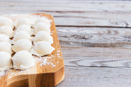 Russian pelmeni on grey wooden background.の写真素材