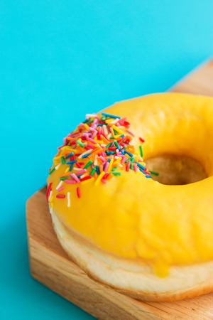One colorful frosting fried american donuts blue backgroundの写真素材