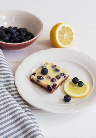 Lemon bars shortbread crumbly crust white table.の写真素材