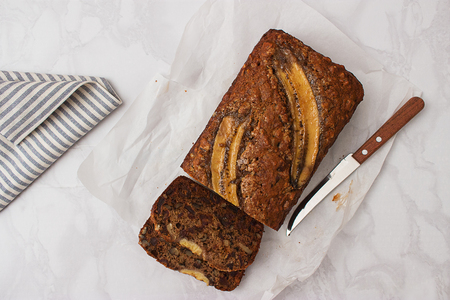 Banana date tea cake easy baked homemade marble table.の写真素材