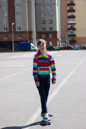 Cute blonde teenager girl trendy skateboard dynamic morning.の写真素材