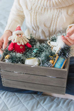 Women sitting on bed with christmas box no faceの写真素材