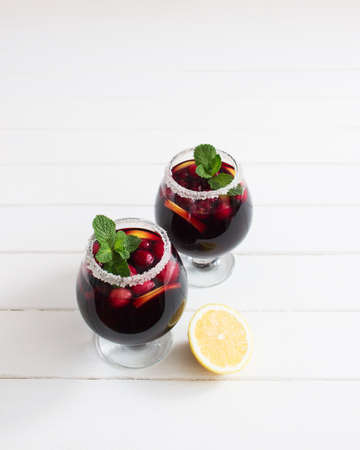 Alcohol cranberry lemon wine peppermint festive cocktail.の写真素材