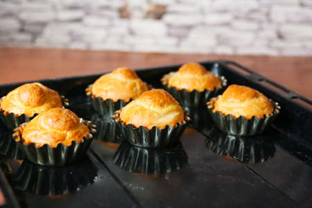 French brioche after oven golden dough black tray kitchen background.