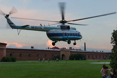 Helicopter hovering on air green lawn.