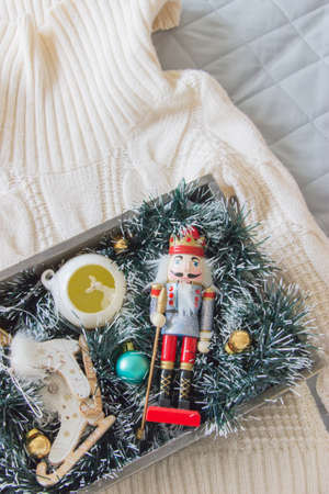 Top view chrismas box with toys on knitted sweaterの写真素材