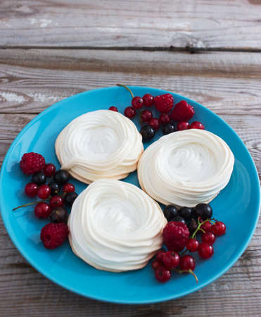 Fresh wonderful trendy mini pavlova cake kitchen wooden table selective focus