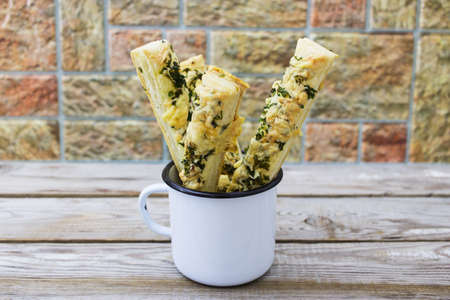 Close up cheese parsley puff pastry stripe cup.