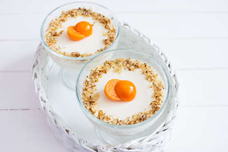 Physalis decorated panna cotta white wicker basket.の写真素材
