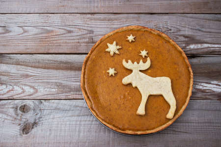 Pumpkin festive pie elk cookies wooden background.の写真素材
