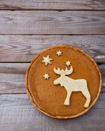 Pumpkin festive pie elk cookies wooden background.の写真素材