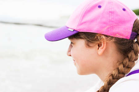 Little girl on sea coastline summer day baseball capの写真素材