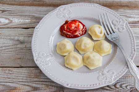 Russian dish meat dumplings pelmeni wooden background.の写真素材
