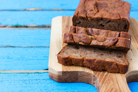 Sliced banana bread on blue wooden background.の写真素材
