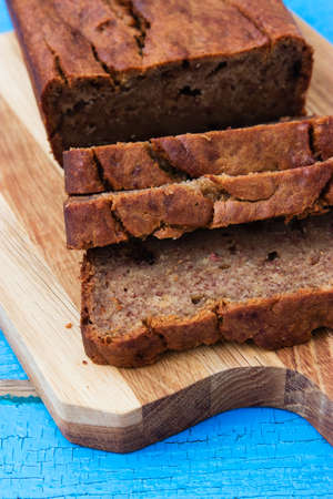 Banana bread on cutting board wooden background.の写真素材