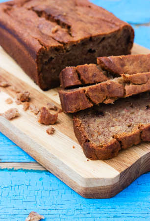 Banana bread on cutting board wooden background.の写真素材