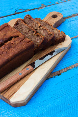 Banana bread on cutting board wooden background.の写真素材