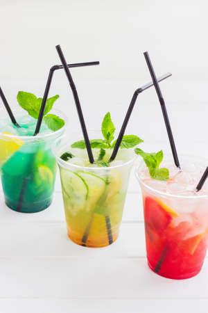 Summer lemonade group plastic cup ice cold white background.の写真素材