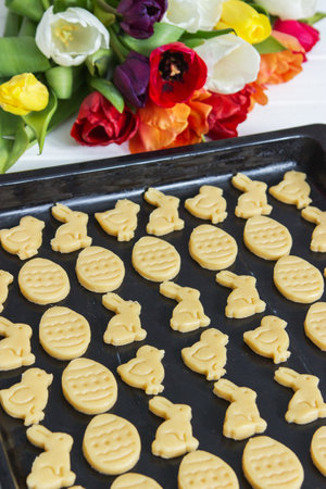 Traditional shortcrust easter cookies spring colorful tulips bouquet.