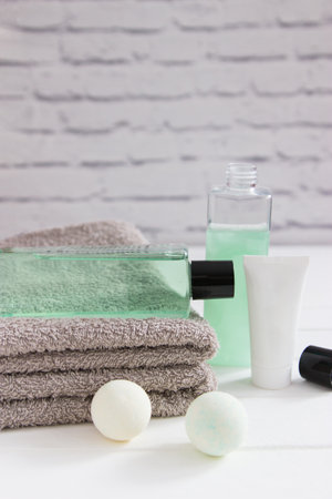 Skin care beauty products gray towels vertical front view.の写真素材