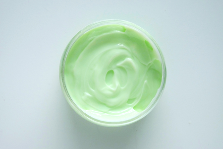 Green aloe vera cream in a round container.の写真素材