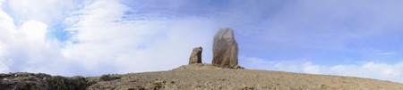View on famous rock Roque Nublo covered in a cloud on the Canary Island Gran Canaria, Spain.の写真素材