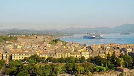 CORFU, GREECE - JULY 05, 2017: Corfu Kerkira with a new fortress Fortezza Nuova and large cruise ships in the new port of the town.のeditorial素材