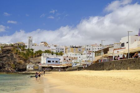 MORRO JABLE, FUERTEVENTURA, SPAIN - JUNE 14, 2017: View on the beach Playa de Matorral and village Morro JAble with unknown tourists on the Canary Island Fuerteventura, Spain.のeditorial素材