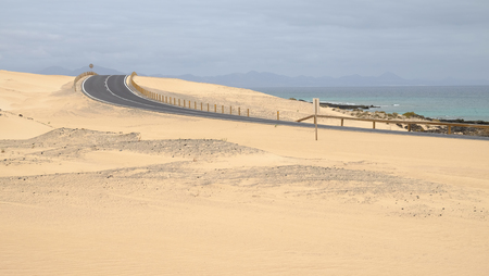 Curved road in the Corralejo Dunes - the Natural Reserve on the Canary Island Fuerteventura, Spain.