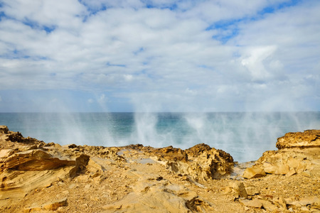 Srays of waves on the beach La Pared on the Canary Island Fuerteventura, Spain.