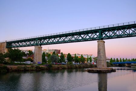 TAVIRA, ALGARVE, PORTUGAL - MAI 25, 2019: View on the iron bridge in Tavira across the river Gilao on the sunset.のeditorial素材