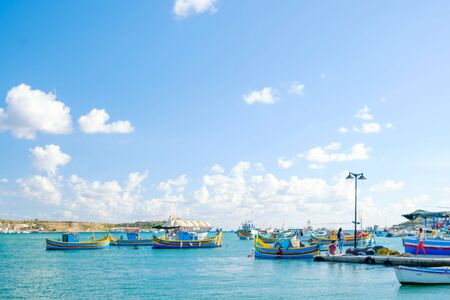MARSAXLOKK, MALTA - 11. NOVEMBER 2019: View on the harbour with colorful boats in Marsaxlokk, Malta.のeditorial素材