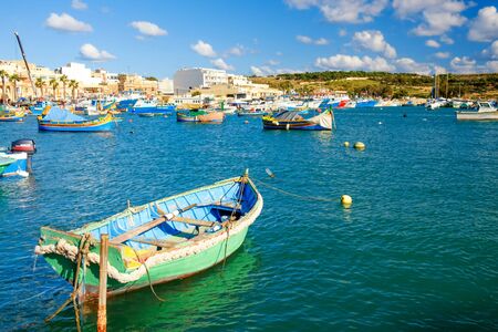 MARSAXLOKK, MALTA - 11. NOVEMBER 2019: View on the harbour with colorful boats in Marsaxlokk, Malta.のeditorial素材