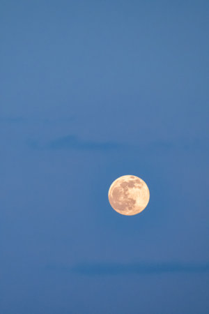 A full moon on the blue sky, close-up.の写真素材