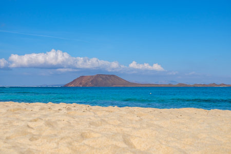 View on Corralejo beach and Lobos island, blue water and golden sand and the Canary Island Fuerteventura, Spain.の写真素材