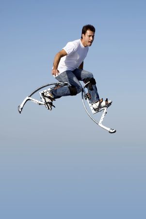 a young man jumping high in the skyの写真素材