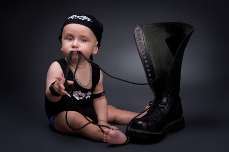 dark portrait of  rocker-baby on a black backgroundの写真素材