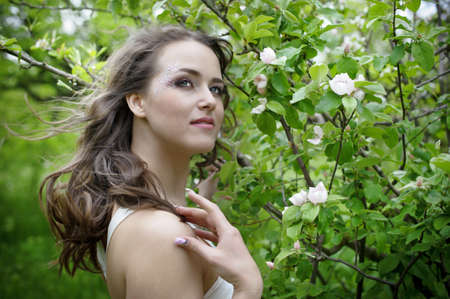 Portrait of the young beautiful smiling woman outdoors